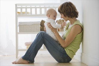 Mother playing with baby.