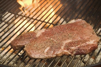 Steak cooking on grill.