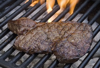 Steak cooking on grill.