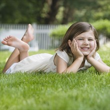 Girl laying in grass.