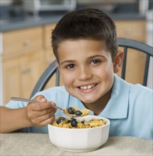Boy eating cereal.