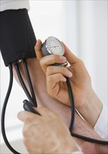 Person having blood pressure measured.