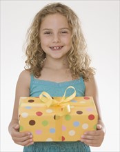 Girl holding gift.