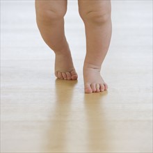 Close up of baby’s feet walking.