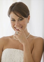 Bride laughing with hand over mouth.