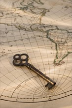 Old fashioned key on globe map.
