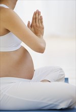 Pregnant woman practicing yoga.
