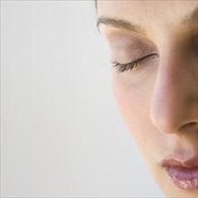 Woman’s face with eye closed.
