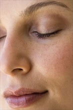 Woman’s face with eyes closed.