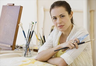 Female artist in painting studio.