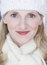 Close up of woman wearing hat and scarf.
