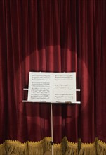 Spotlight on sheet music on stage.