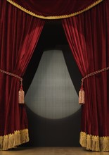 Spotlight on open stage curtains.