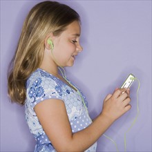 Girl listening to mp3 player.
