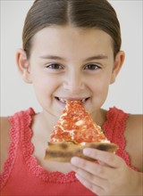 Girl eating pizza.