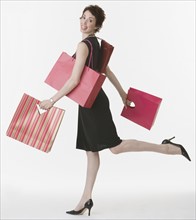 Woman carrying shopping bags.