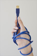 Woman holding USB cable.
