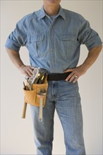 Man wearing tool belt.