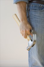 Man holding hammer and nails.