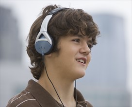 Teenaged boy wearing headphones.