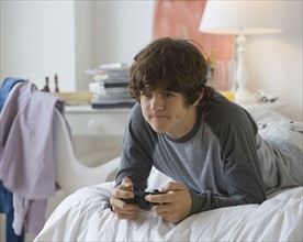 Teenaged boy playing video games.