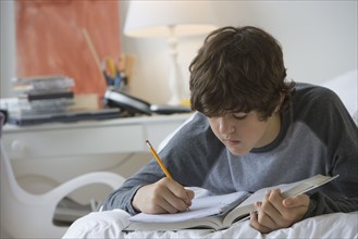 Teenaged boy doing homework.