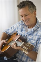 Man playing acoustic guitar.