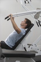 Man exercising at gym.
