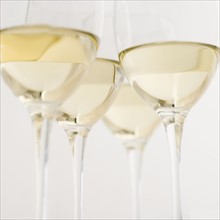 Glasses of white wine seen from below. Date : 2006