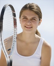 Girl holding tennis racket.