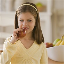 Girl eating apple.