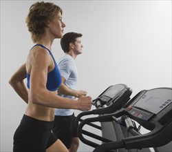 Couple running on treadmills.
