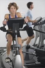 Couple exercising at gym.