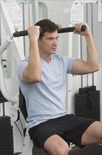Man exercising at gym.