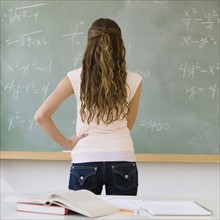 Girl looking at blackboard.