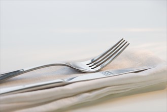 Close up of silverware on napkin.