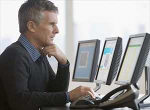 Businessman typing on computer.