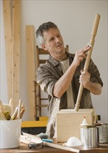 Man sanding piece of wood.