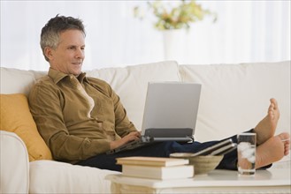 Man typing on laptop.