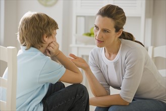 Mother having discussion with son.
