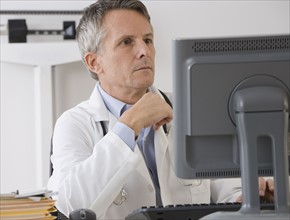 Male doctor looking at computer.
