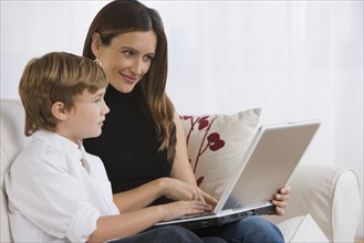 Mother and son looking at laptop.