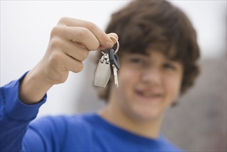 Teenaged boy holding car keys.