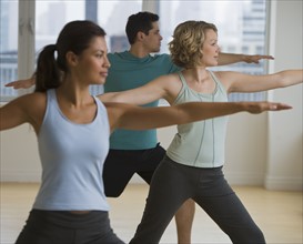 Multi-ethnic people in yoga class.