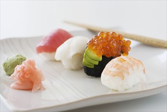 Close up of assorted sushi on plate .