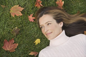 Woman laying in grass.