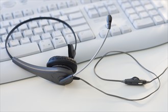 Close up of headset on computer keyboard.