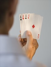 Man holding four aces.