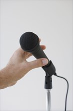 Man reaching for microphone.