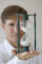 Man holding hourglass.
